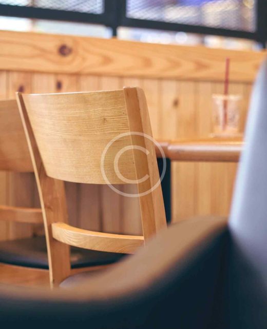 Wooden chairs in a cozy dining setting.